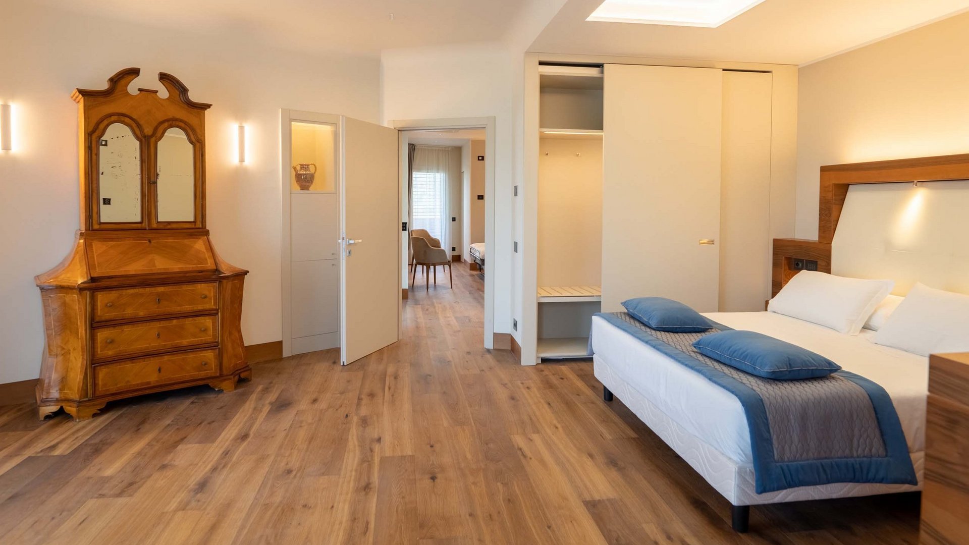 Un hotel a Santa Maria degli Angeli, Assisi? No, molto di più Camera da letto moderna con letto matrimoniale, armadio bianco e cassettiera vintage